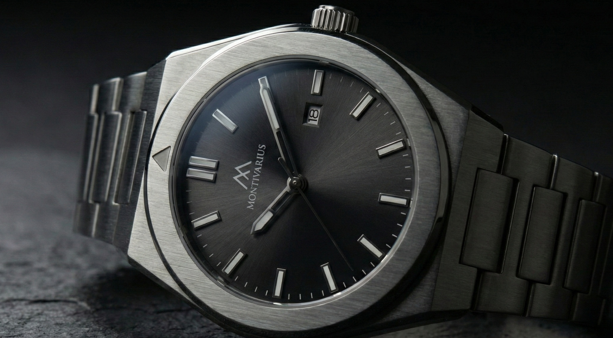 Black watch with metallic band on a dark textured surface